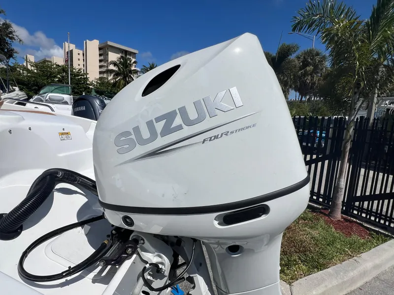 Slide: The Image of Suzuki four-stroke outboard motor on a 2024 NauticStar 193SC Sport Deck boat. - 12
