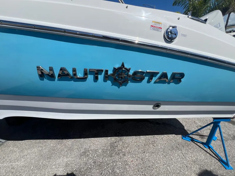 Slide: The Image of 2024 NauticStar 193SC Sport Deck boat side view with logo. - 18