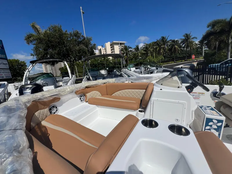 Slide: The Image of 2024 NauticStar 193SC Sport Deck boat with tan seating and cup holders. - 9
