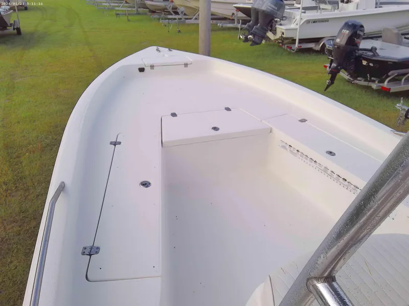 Slide: The Image of 2008 Clearwater 2400 Baystar Bay Boat, white interior, parked on grass with other boats. - 8