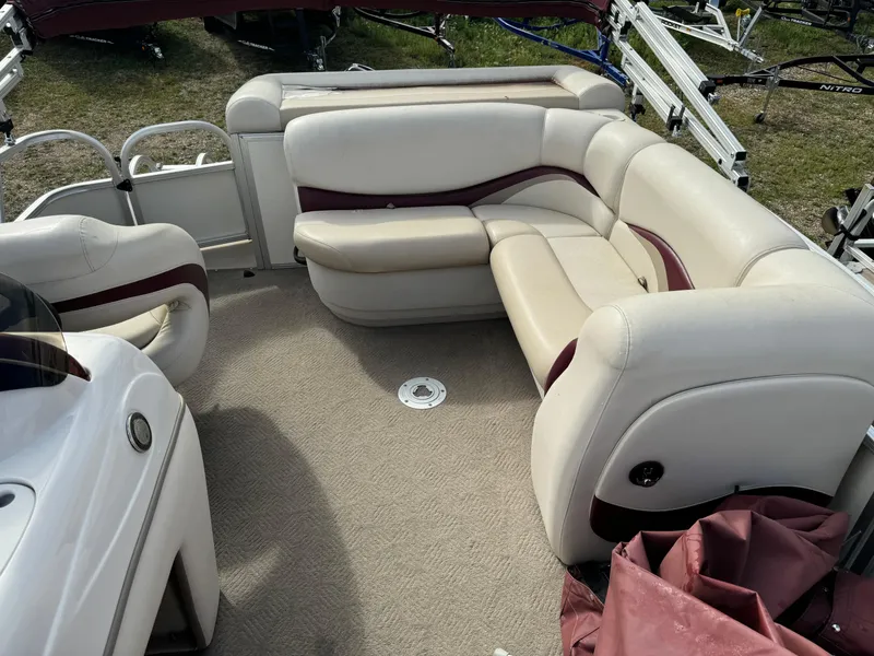 Slide: The Image of 2011 Sun Tracker Party Barge 21 interior with beige and maroon seating. - 10
