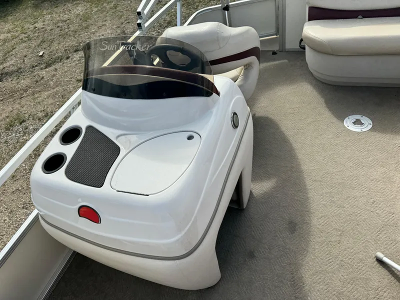 Slide: The Image of 2011 Sun Tracker Party Barge 21 helm with steering wheel and seating area. - 11