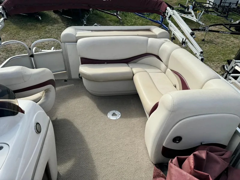 Slide: The Image of 2011 Sun Tracker Party Barge 21 interior with beige seating and maroon accents. - 12