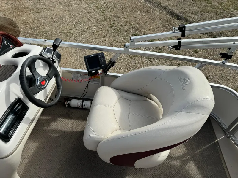 Slide: The Image of 2011 Sun Tracker Party Barge 21 helm with steering wheel and captain's chair. - 13