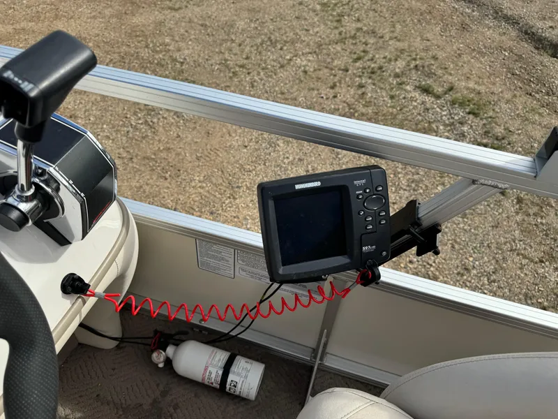 Slide: The Image of Control panel of a 2011 Sun Tracker Party Barge 21 with a fish finder and fire extinguisher. - 14