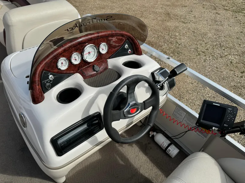 Slide: The Image of 2011 Sun Tracker Party Barge 21 dashboard with steering wheel and gauges. - 15