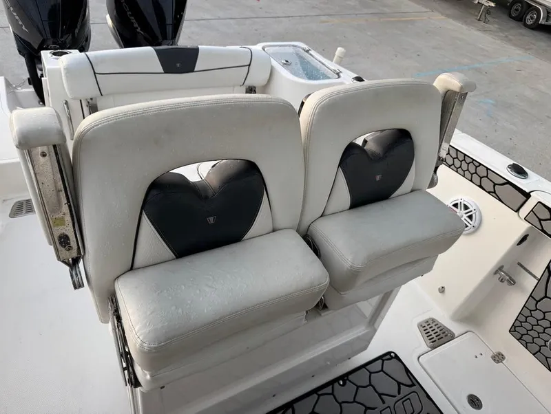 Slide: The Image of 2019 Wellcraft 262 Fisherman boat seats, featuring dual cushioned chairs with black accents. - 15