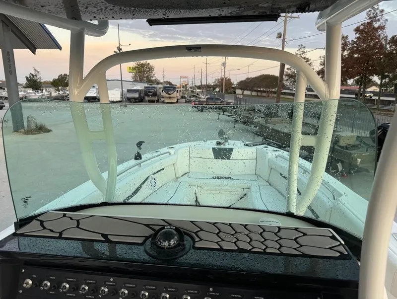 Slide: The Image of 2019 Wellcraft 262 Fisherman boat interior with wet windshield and console view. - 16