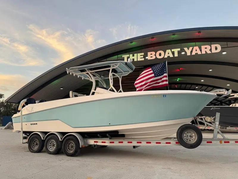 Slide: The Image of 2019 Wellcraft 262 Fisherman boat on trailer at The Boat Yard, with American flag. - 2