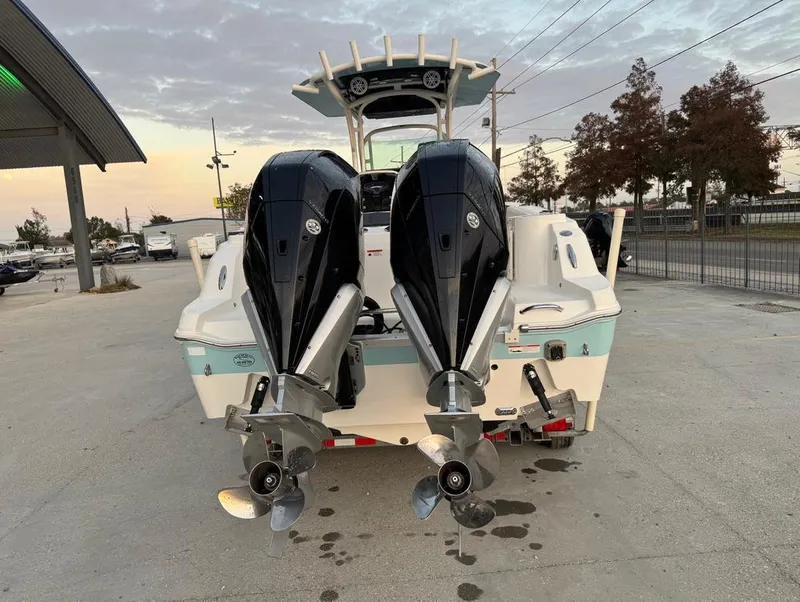 Slide: The Image of 2019 Wellcraft 262 Fisherman boat with dual outboard engines, parked on concrete. - 4