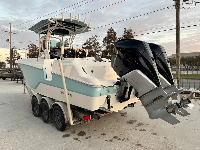 Slide: The Image of 2019 Wellcraft 262 Fisherman boat on trailer with dual outboard engines. - 5