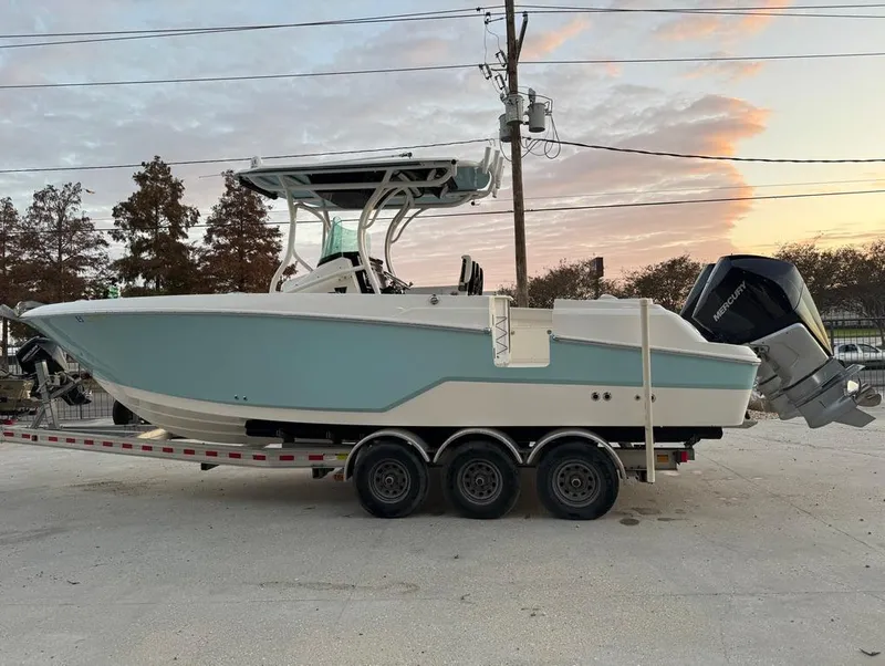 Slide: The Image of 2019 Wellcraft 262 Fisherman boat on trailer at sunset. - 6