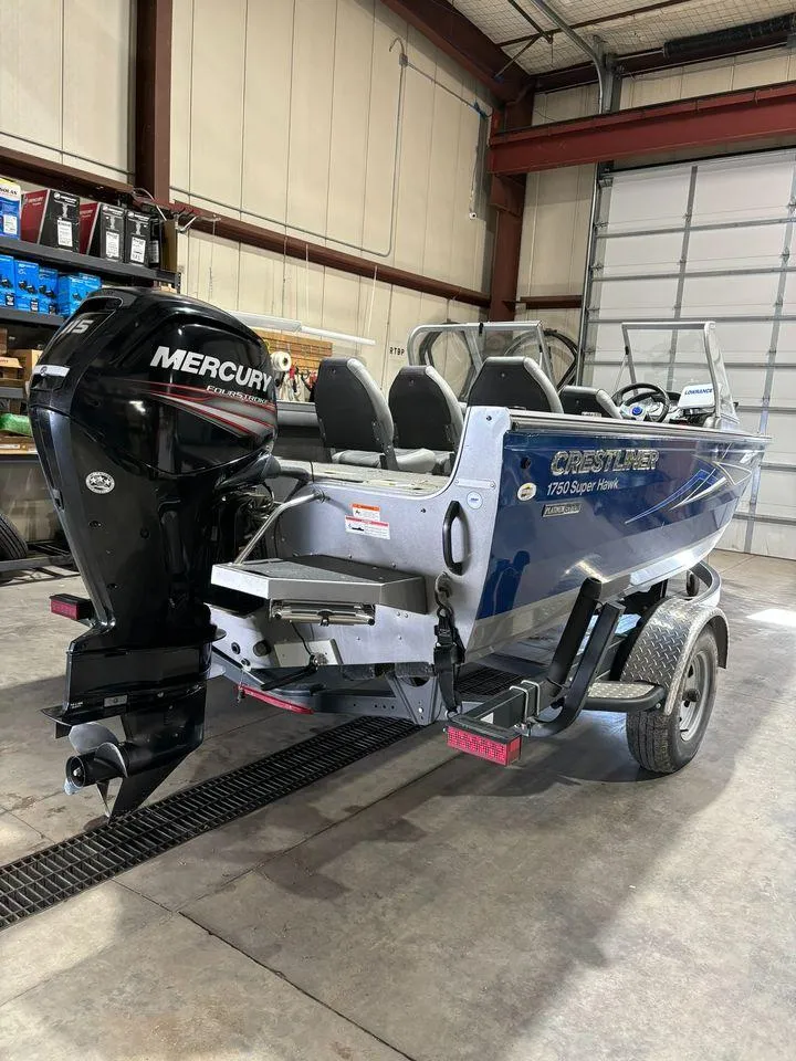 Slide: The Image of 2016 Crestliner 1750 Super Hawk boat with Mercury outboard motor in a garage. - 2