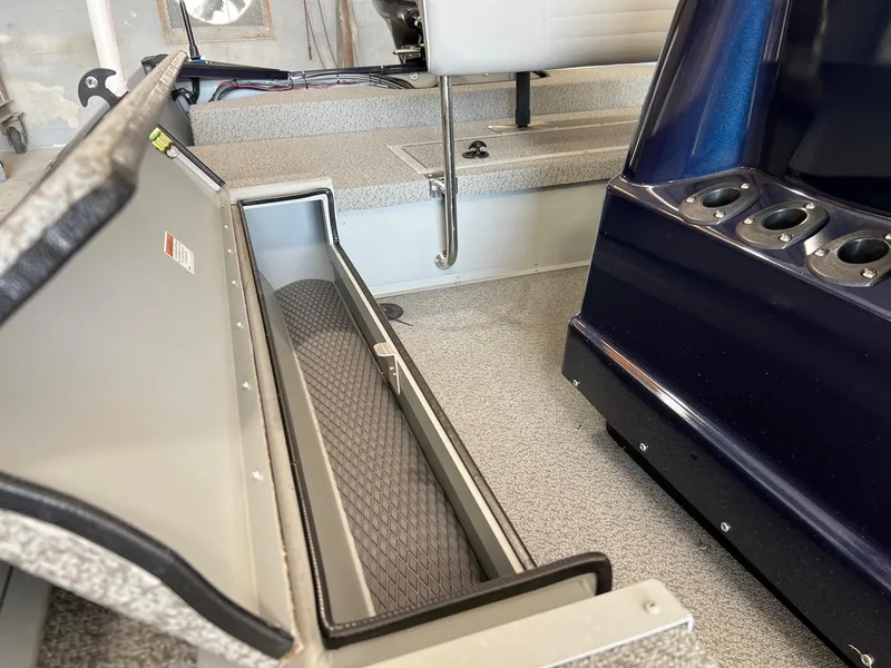 Slide: The Image of 2024 SeaArk 2072 FXT boat interior with storage compartment and seating. - 14