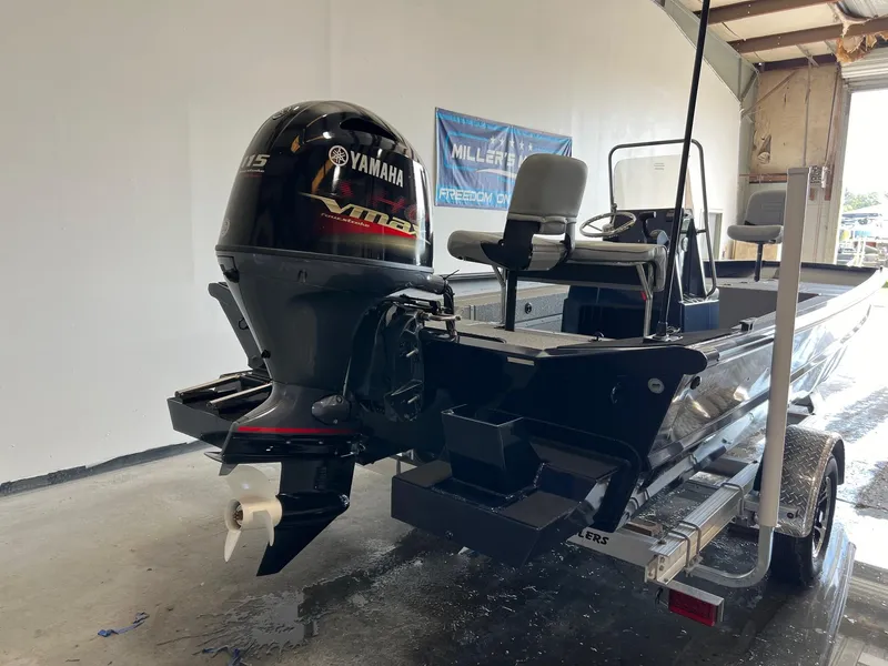 Slide: The Image of 2024 SeaArk 2072 FXT boat with Yamaha outboard motor in a garage. - 3