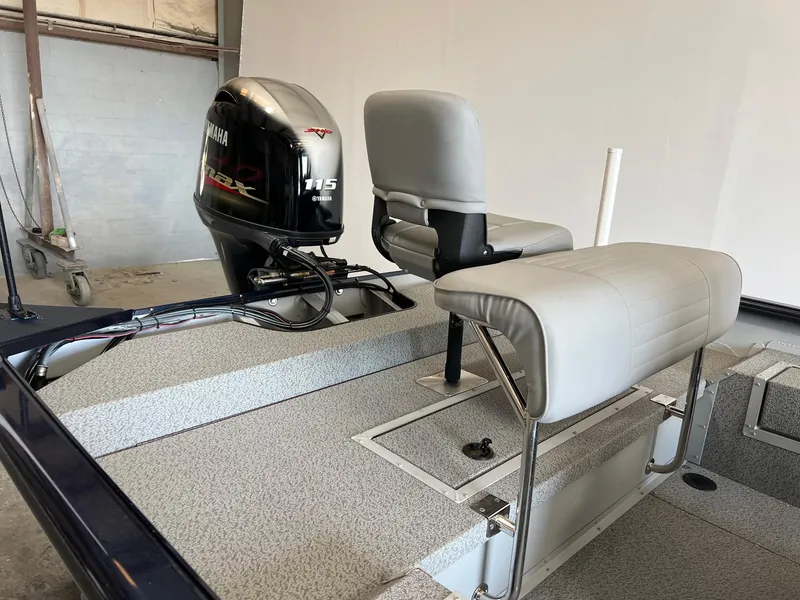Slide: The Image of 2024 SeaArk 2072 FXT boat with Yamaha 115 HP outboard motor and seating. - 9