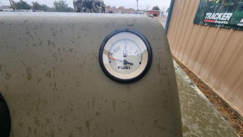 Slide: The Image of Fuel gauge on 2025 Tracker GRIZZLY® 1754 SC boat dashboard, outdoors. - 10