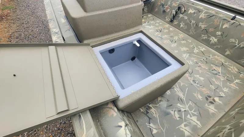 Slide: The Image of 2025 Tracker GRIZZLY® 1754 SC boat with open storage compartment, camo design. - 14