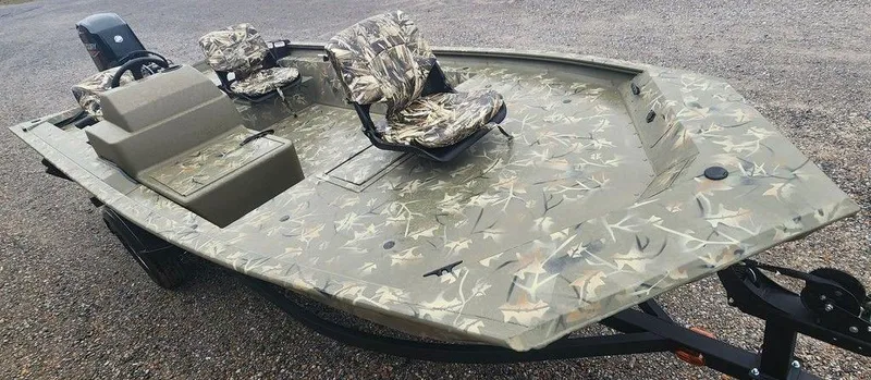 Slide: The Image of 2025 Tracker GRIZZLY® 1754 SC boat with camouflage design on gravel surface. - 17