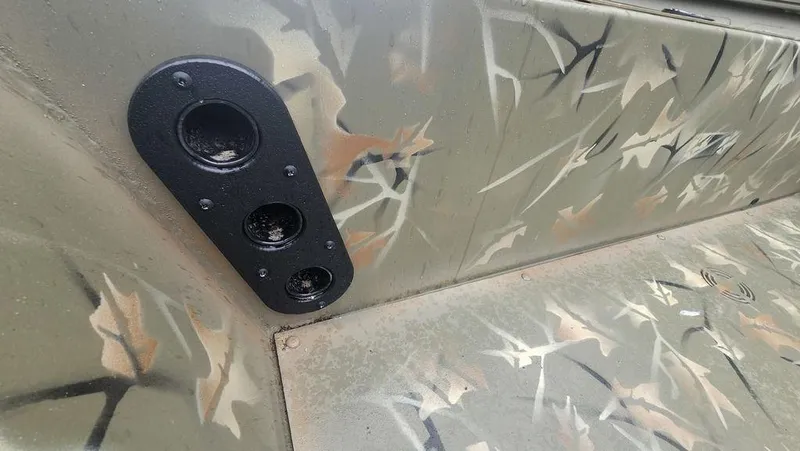 Slide: The Image of 2025 Tracker GRIZZLY® 1754 SC interior with camouflage design and speaker panel. - 19