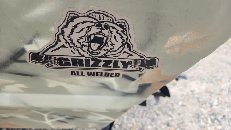 Slide: The Image of Tracker GRIZZLY® 1754 SC 2025 logo with bear graphic and "All Welded" text. - 2