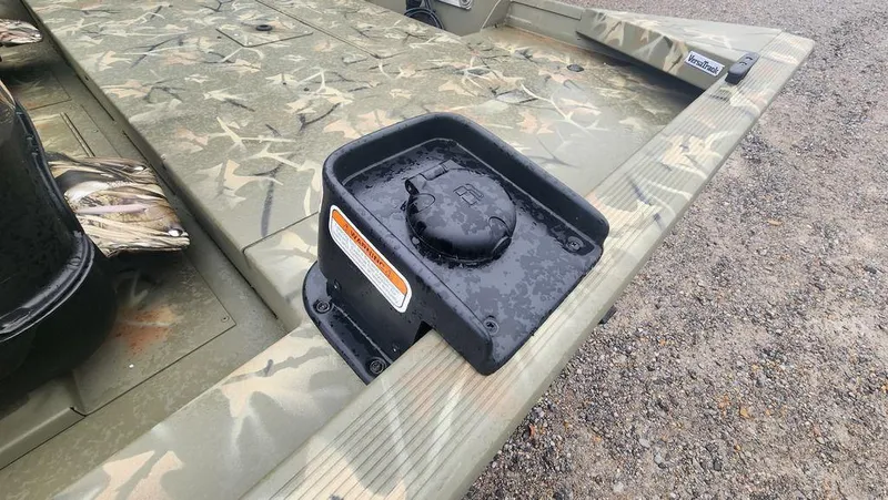 Slide: The Image of 2025 Tracker GRIZZLY® 1754 SC boat with camouflage design and secure storage compartment. - 23