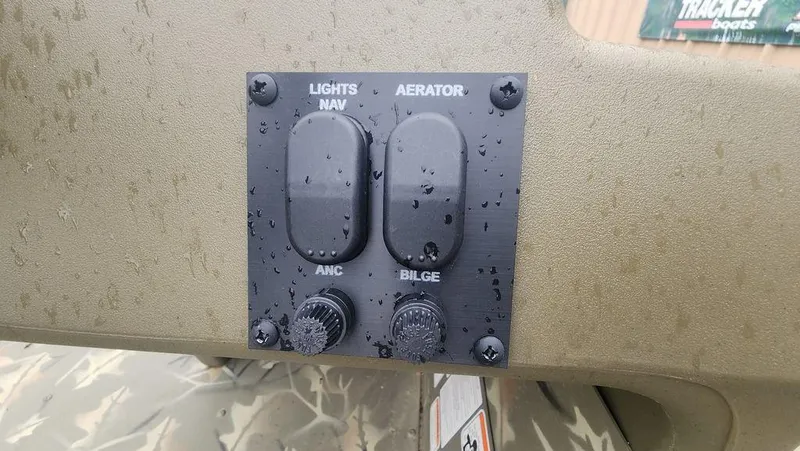 Slide: The Image of Control panel of 2025 Tracker GRIZZLY® 1754 SC boat with switches for lights and aerator. - 8