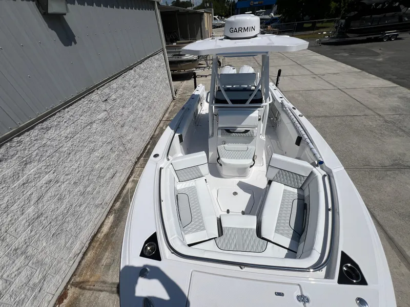 Slide: The Image of 2024 Blackfin 252 CC boat with Garmin navigation system, docked near a building. - 10
