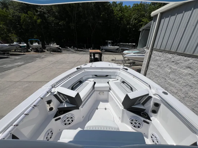 Slide: The Image of 2024 Blackfin 252 CC boat interior with seating and speakers. - 11