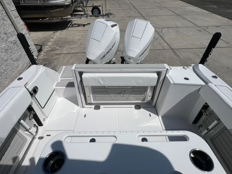 Slide: The Image of 2024 Blackfin 252 CC boat with twin Mercury outboard engines, rear deck view. - 12
