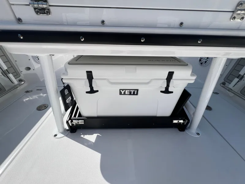 Slide: The Image of 2024 Blackfin 252 CC boat with Yeti cooler in storage compartment. - 14