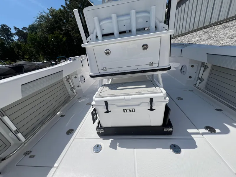 Slide: The Image of 2024 Blackfin 252 CC boat deck with Yeti cooler and storage compartments. - 23