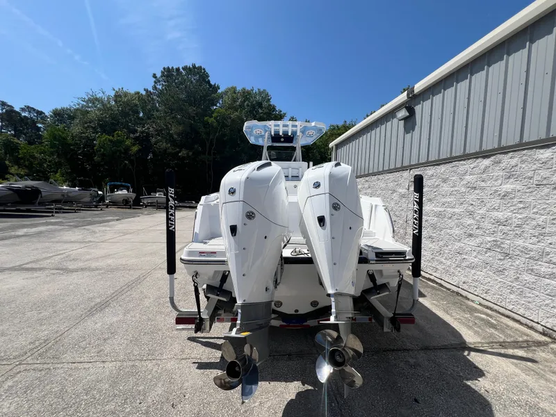Slide: The Image of 2024 Blackfin 252 CC boat with twin outboard engines, rear view. - 3