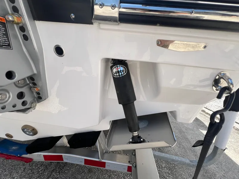 Slide: The Image of Close-up of 2024 Blackfin 252 CC boat's hydraulic system and trailer. - 31