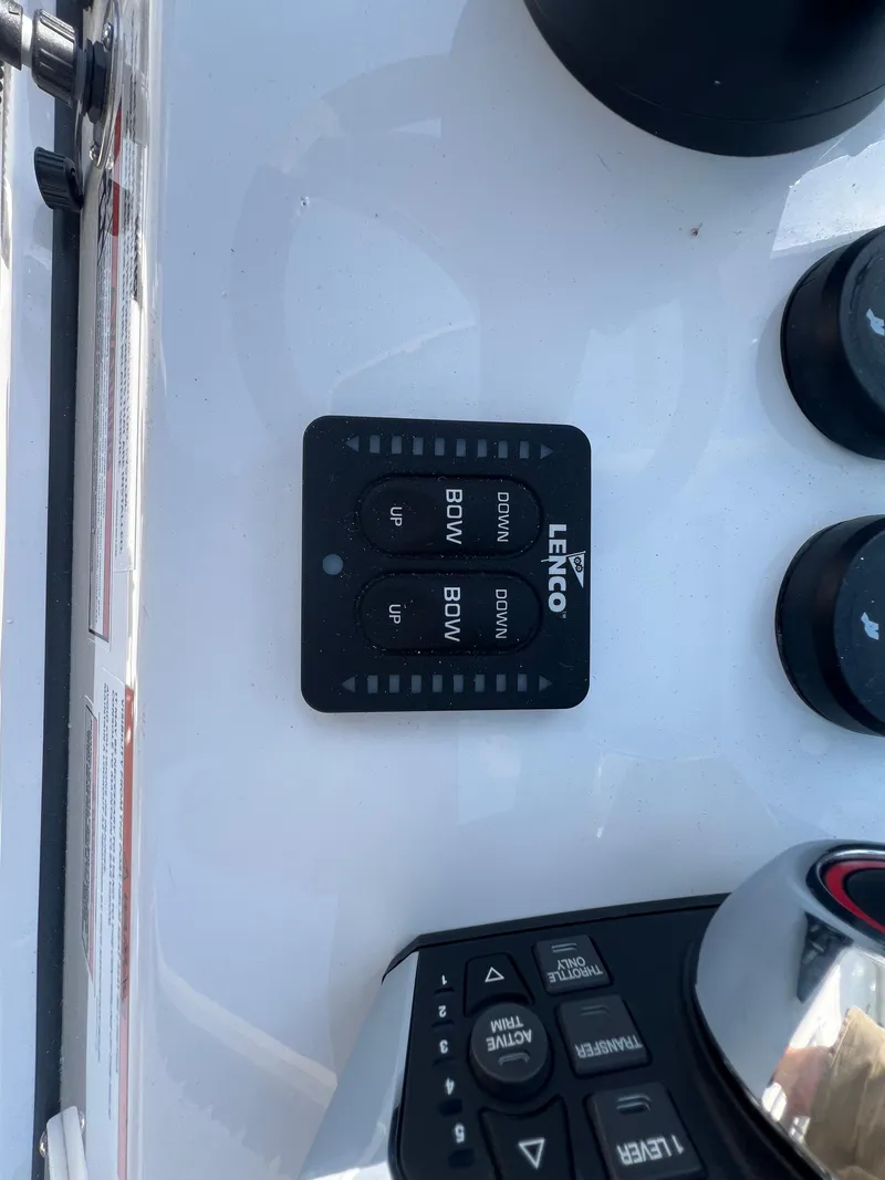 Slide: The Image of Control panel of a 2024 Blackfin 252 CC boat with Lenco trim tab switches. - 32