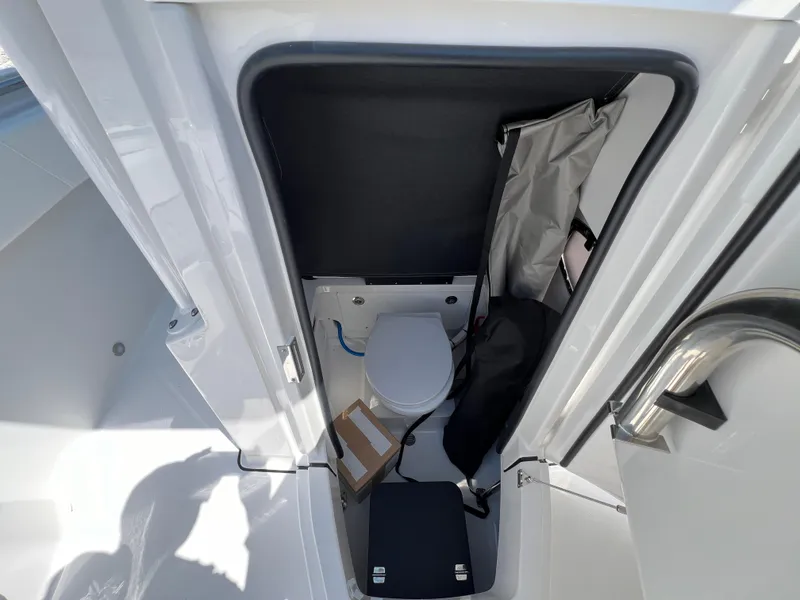 Slide: The Image of 2024 Blackfin 252 CC boat interior with compact marine toilet. - 44
