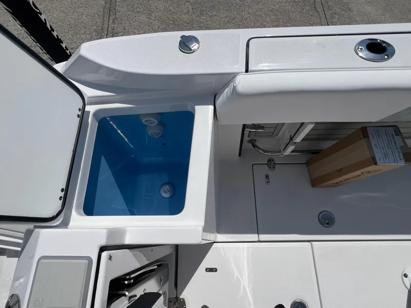 Slide: The Image of 2024 Blackfin 252 CC boat interior with storage compartments and seating. - 45