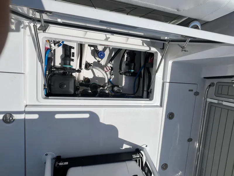 Slide: The Image of 2024 Blackfin 252 CC boat interior compartment with mechanical components. - 46