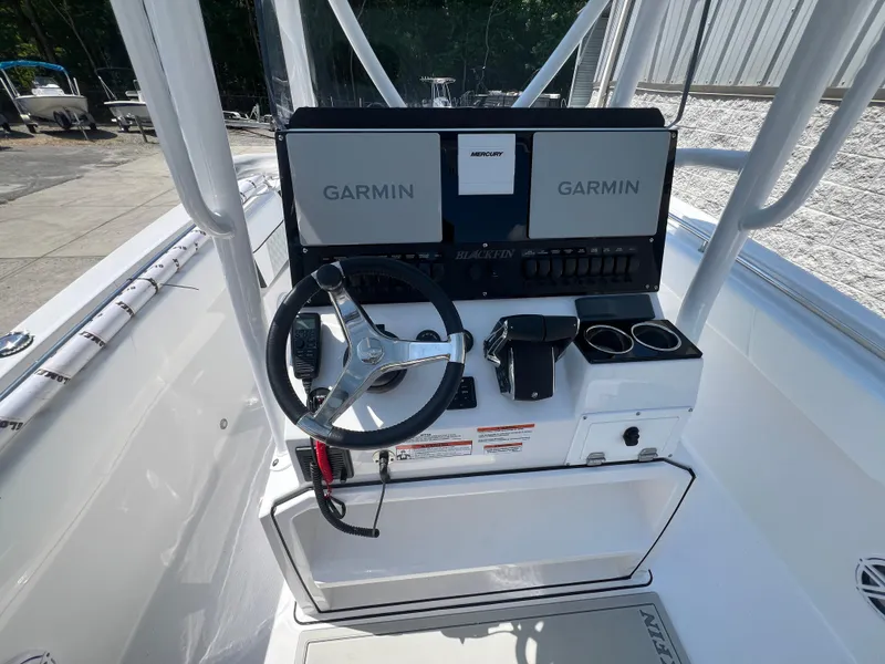 Slide: The Image of 2024 Blackfin 252 CC boat console with Garmin navigation system and steering wheel. - 7