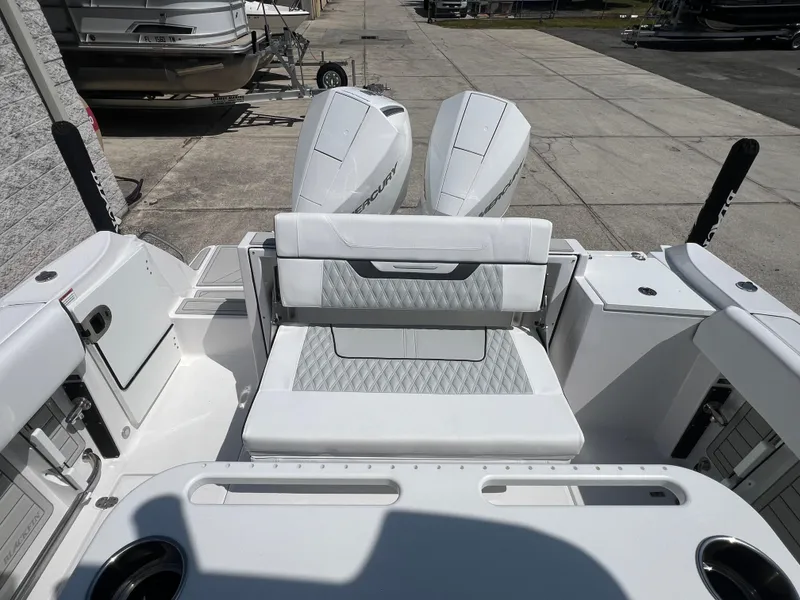 Slide: The Image of 2024 Blackfin 252 CC boat with dual outboard engines and white seating. - 9