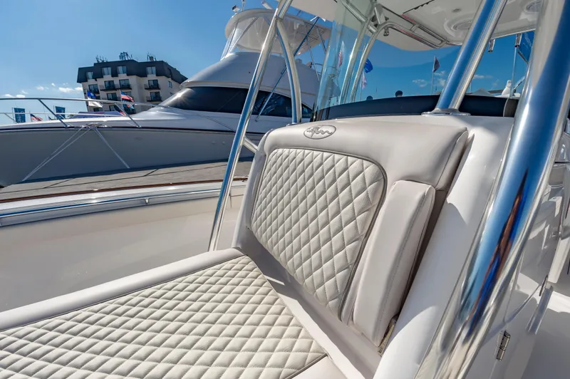 Slide: The Image of 2025 Valhalla Boatworks V-29 with luxurious quilted seating, docked under clear blue skies. - 10