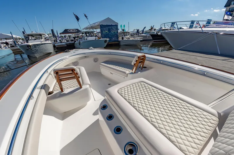 Slide: The Image of 2025 Valhalla Boatworks V-29 with luxurious seating at a marina. - 11