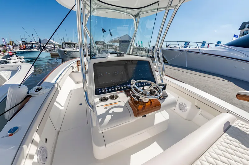 Slide: The Image of 2025 Valhalla Boatworks V-29 helm with modern controls at a marina. - 12