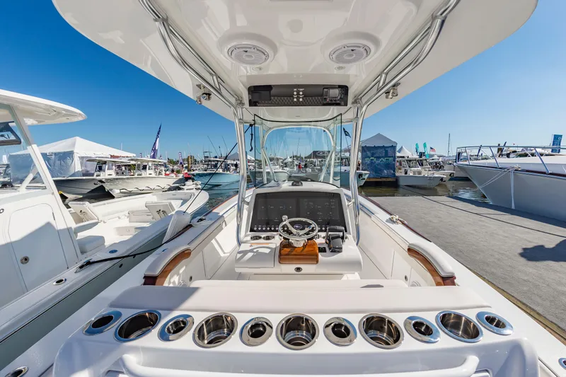 Slide: The Image of 2025 Valhalla Boatworks V-29 center console at a marina, showcasing helm and controls. - 15