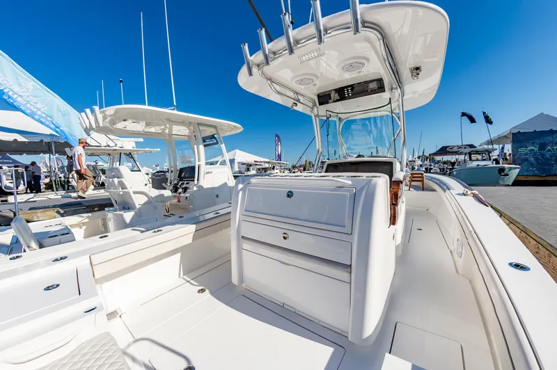 Slide: The Image of 2025 Valhalla Boatworks V-29 center console at a boat show under clear blue skies. - 17