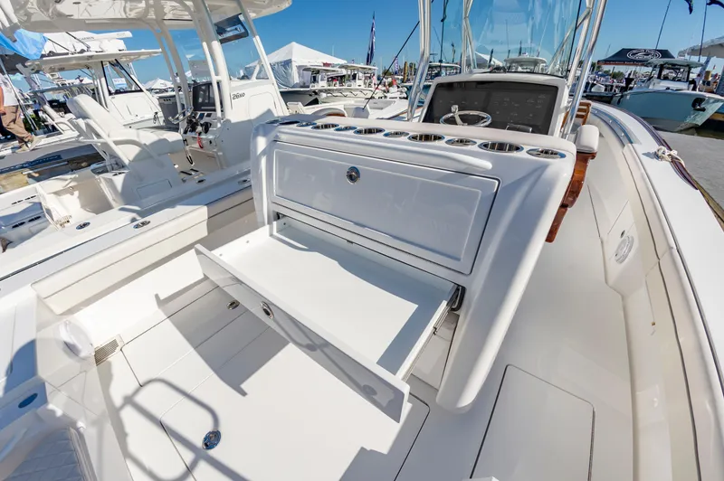 Slide: The Image of 2025 Valhalla Boatworks V-29 interior with open storage compartment, showcasing sleek design. - 19