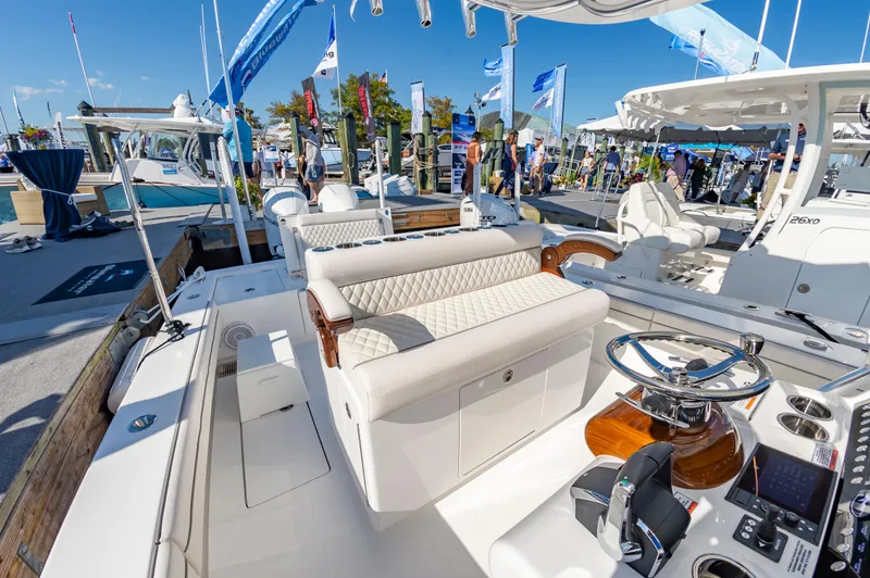 Slide: The Image of 2025 Valhalla Boatworks V-29 at a boat show, featuring luxurious seating and modern controls. - 22