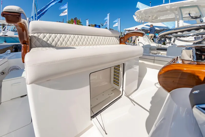 Slide: The Image of 2025 Valhalla Boatworks V-29 luxury seating and storage detail at a boat show. - 23