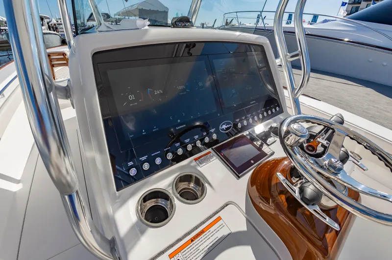 Slide: The Image of 2025 Valhalla Boatworks V-29 dashboard with modern navigation controls and steering wheel. - 25