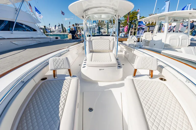Slide: The Image of 2025 Valhalla Boatworks V-29 with luxurious white seating at a boat show. - 27